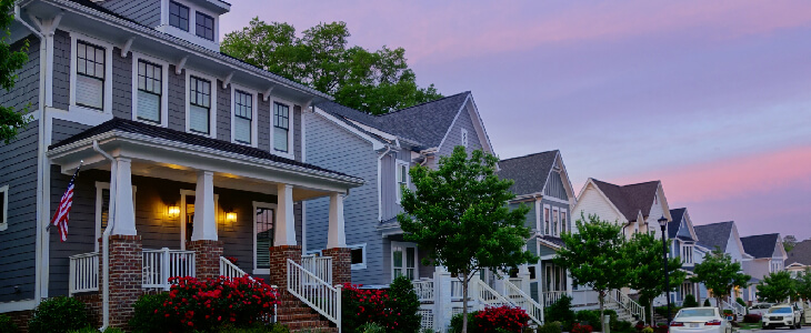 beautiful homes on a street where the sun is setting residential real estate